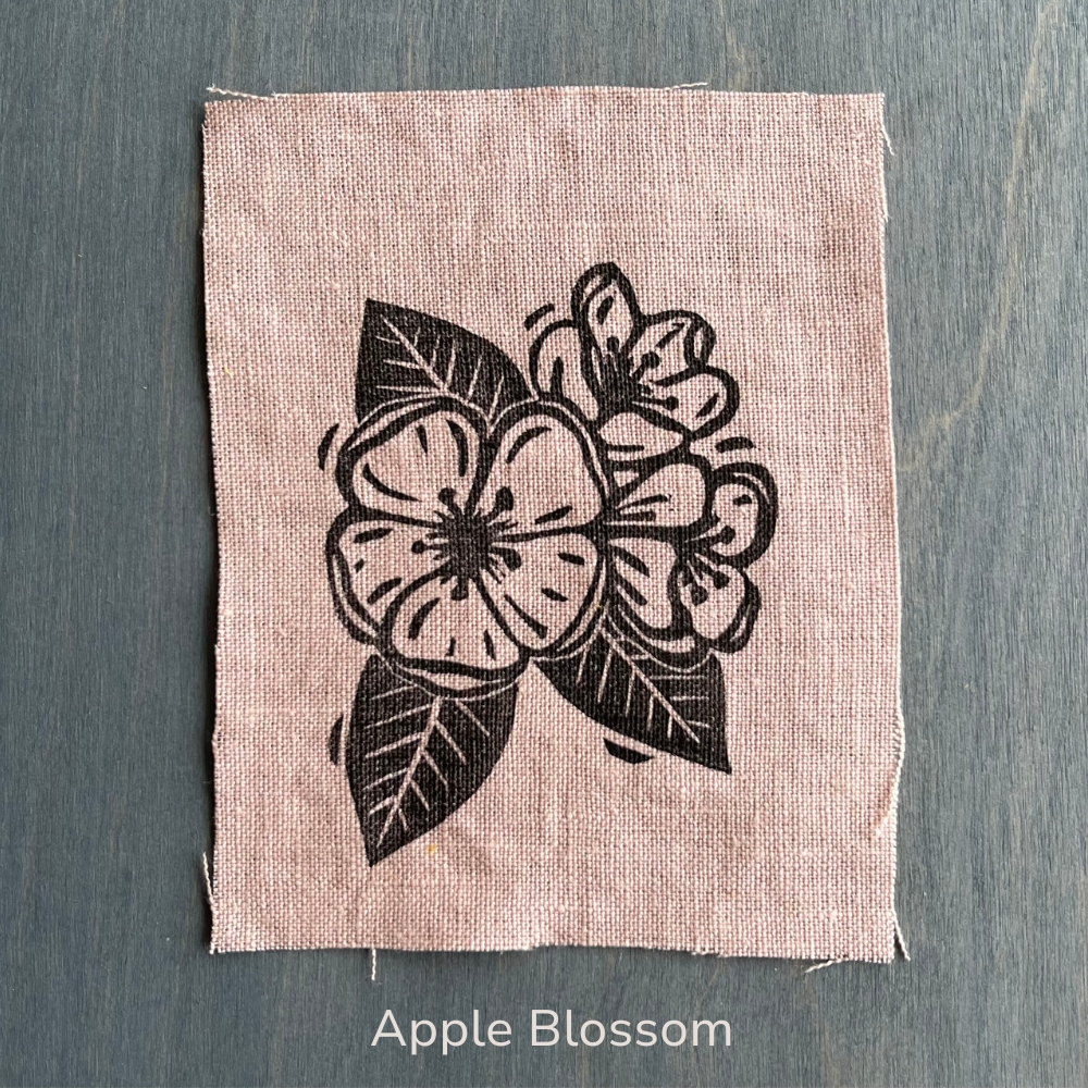 pink apple blossom block-printed wildflower patch on a blue table


