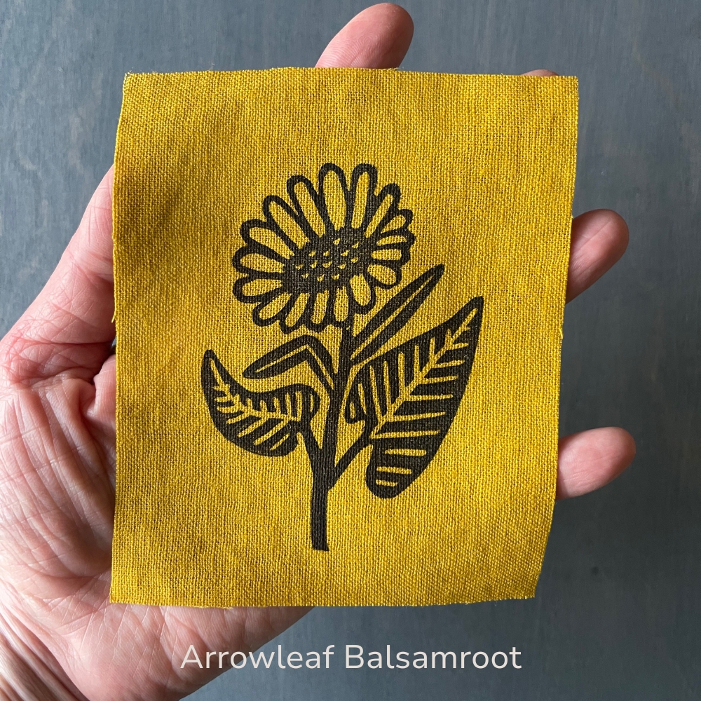 hand holding a yellow arrowleaf balsamroot linen patch