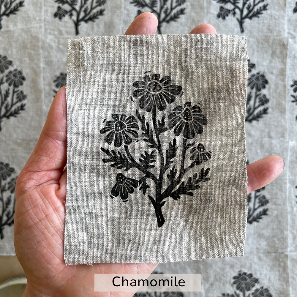 hand holding a beige chamomile flower linen patch