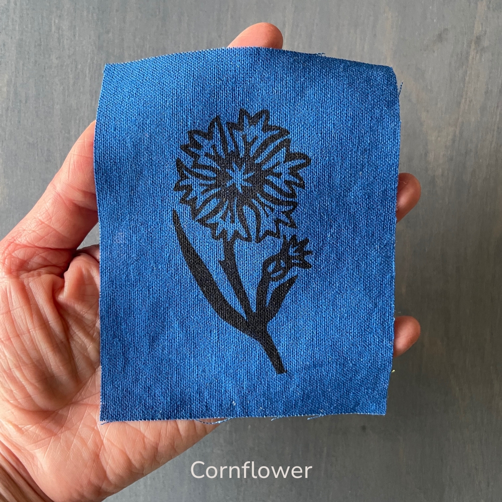 hand holding a blue cornflower linen  patch