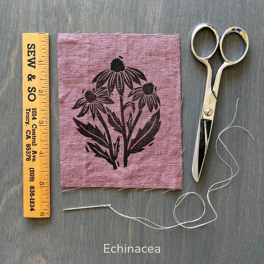 hand holding a purple echinacea flower linen patch
