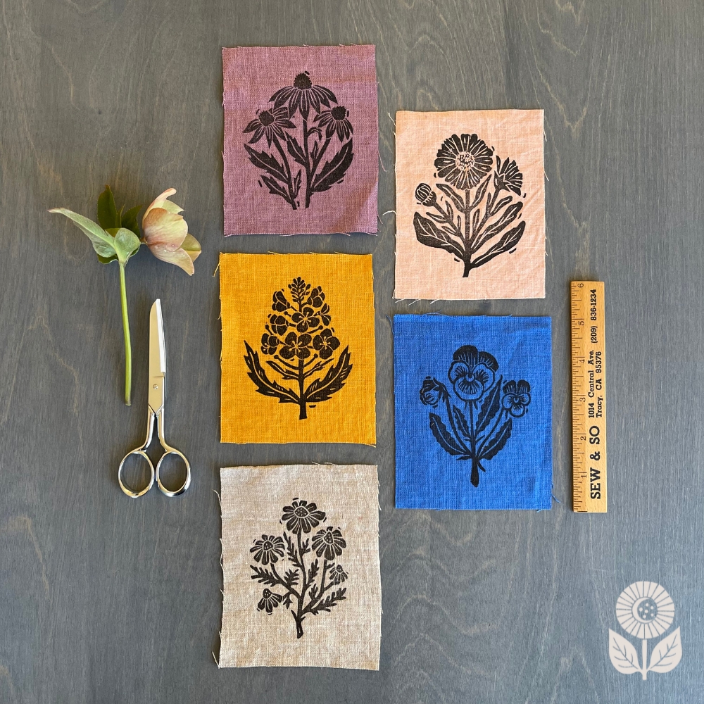 five linen wildflower patches laying on a table
